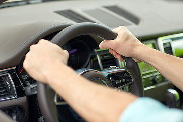 Image showing close up of male hands driving car