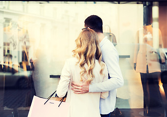 Image showing couple with shopping bags looking at shop window