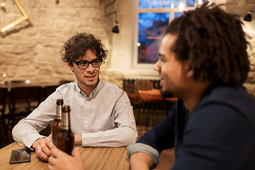 Image showing happy male friends drinking beer at bar or pub