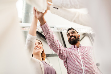 Image showing happy business team making high five at office