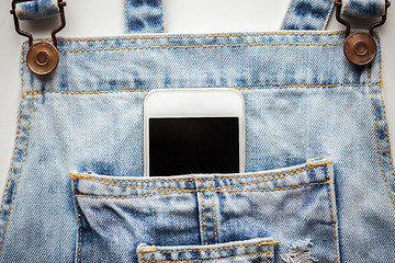 Image showing smartphone in pocket of denim overalls