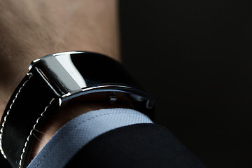 Image showing close up of businessman hand with smart watch