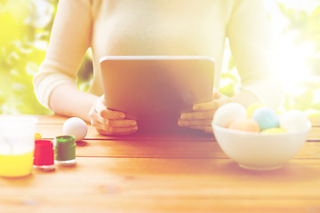 Image showing close up of woman with tablet pc and easter eggs