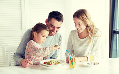 Image showing happy family having dinner at restaurant or cafe