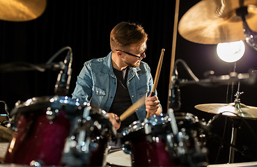 Image showing male musician playing drums and cymbals at concert