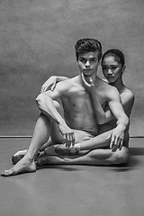 Image showing Couple of ballet dancers posing over gray background