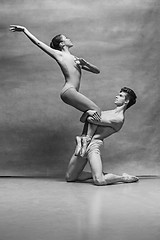 Image showing Couple of ballet dancers posing over gray background