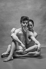 Image showing Couple of ballet dancers posing over gray background