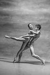 Image showing Couple of ballet dancers posing over gray background