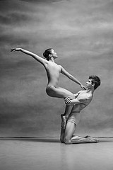 Image showing Couple of ballet dancers posing over gray background