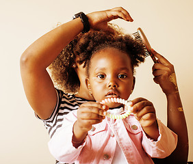 Image showing adorable sweet young afro-american mother with cute little daughter, hanging at home, having fun playing smiling, lifestyle people concept, happy smiling modern family 