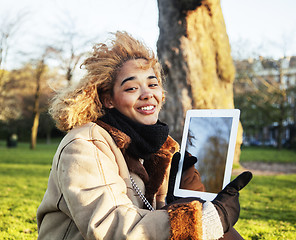 Image showing young cute blond african american girl student holding tablet and smiling, lifestyle people concept 