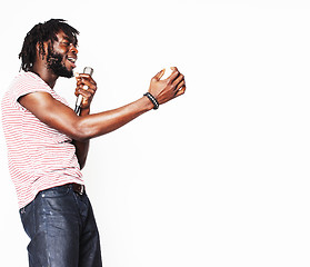 Image showing young handsome african american boy singing emotional with microphone isolated on white background, in motion gesturing smiling, lifestyle people concept 