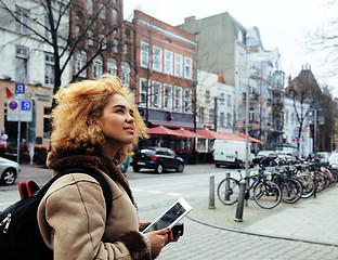 Image showing young cute blond african american girl student holding tablet and smiling, lifestyle people concept 