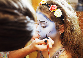 Image showing little cute child making facepaint on birthday party, zombie Apo