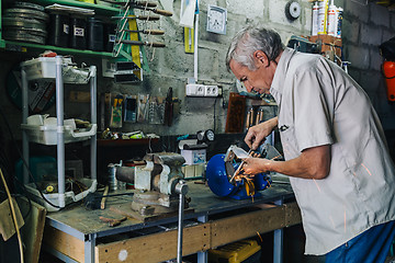 Image showing Close-up of workman working with iron