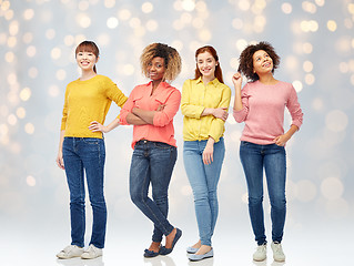 Image showing happy young women over lights background