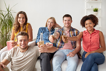 Image showing happy friends with popcorn and beer at home