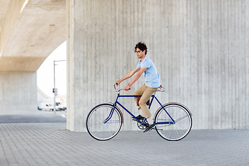 Image showing young hipster man riding fixed gear bike