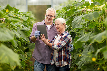 Image showing senior couple with tablet pc at farm greenhouse