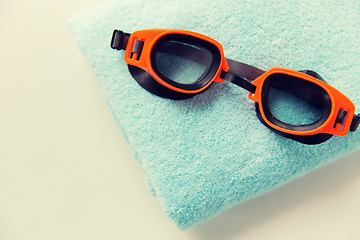 Image showing close up of swimming goggles and towel