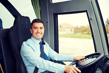 Image showing happy driver driving intercity bus