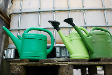 Image showing watering cans at farm water tank