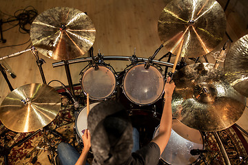 Image showing male musician playing drums and cymbals at concert