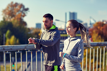 Image showing couple running over city highway bridge