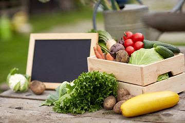 Image showing close up of vegetables with chalkboard on farm