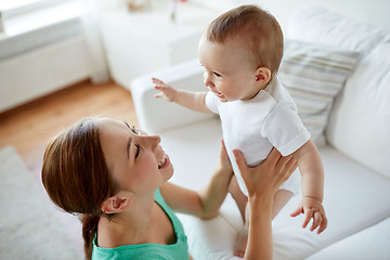 Image showing happy young mother with little baby at home