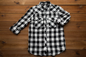 Image showing checkered shirt on wooden background