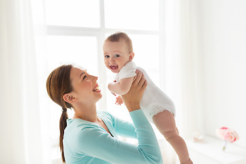 Image showing happy young mother with little baby at home