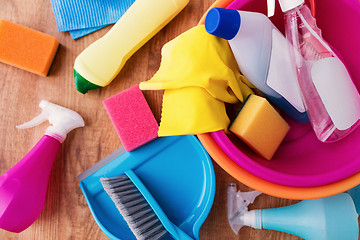 Image showing basin with cleaning stuff on wooden floor