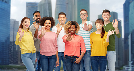 Image showing international group of happy people waving hand