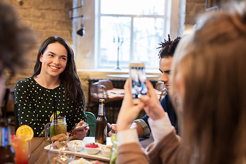 Image showing friends with smartphone photographing at cafe