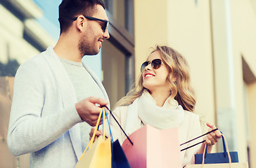 Image showing happy couple with shopping bags on city street