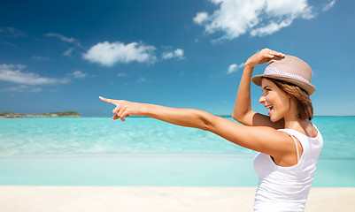 Image showing happy young woman in hat on summer beach