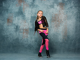 Image showing Young girl break dancing on wall background.