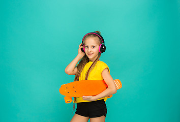 Image showing Pretty skater girl holding skateboard