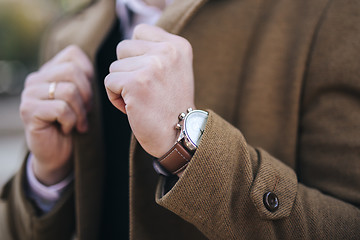 Image showing Men watches on hand in coat