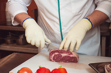 Image showing Chef cutting meat