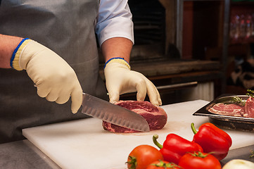 Image showing Chef cutting meat