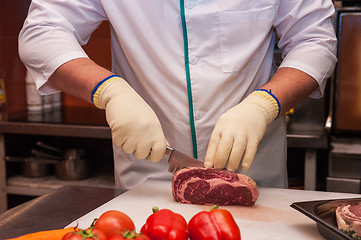 Image showing Chef cutting meat