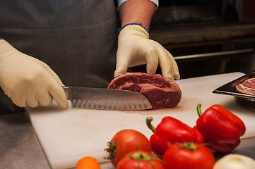 Image showing Chef cutting meat