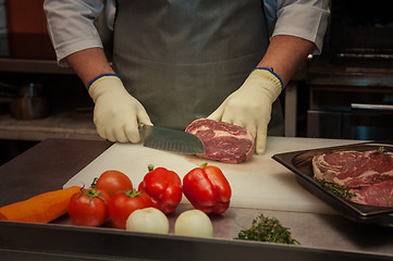 Image showing Chef cutting meat