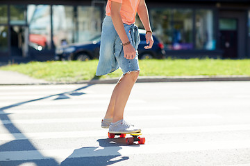 Image showing teenage boy on skateboard crossing city crosswalk