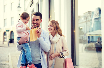 Image showing happy family with child and shopping bags in city