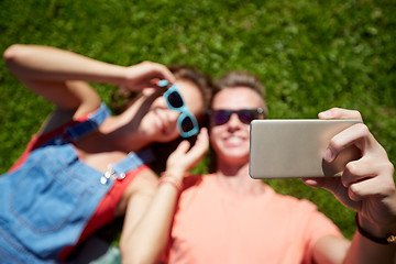 Image showing happy couple taking selfie on smartphone at summer