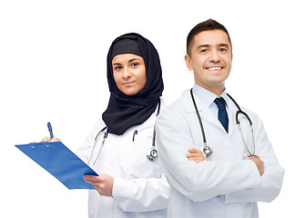 Image showing happy doctors with clipboard and stethoscopes